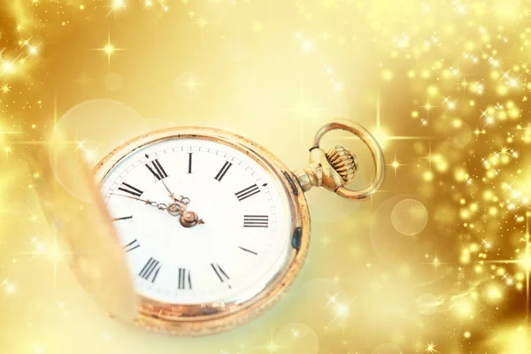 Gold clock showing midnight — Stock Photo, Image