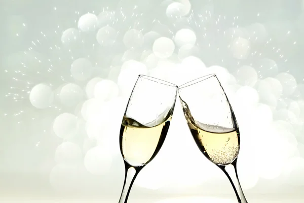 Glasses with champagne against holiday lights — Stock Photo, Image