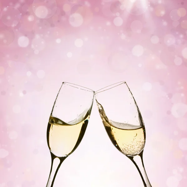 Toasting with champagne glasses on sparkling holiday background Stock