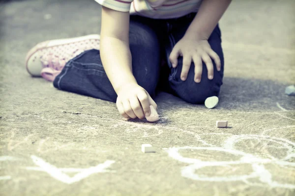 Photo of girl writing with chalk on the schoolyard — Stock Photo, Image