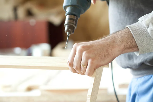 Man's arms drill lath — Stock Photo, Image