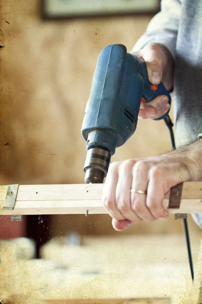 Man's arms drill lath in the workshop — Stock Photo, Image