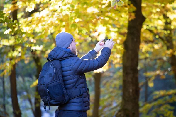 Man Taking Photos Autumn Forest Hiking Travel Concept — Stock Photo, Image