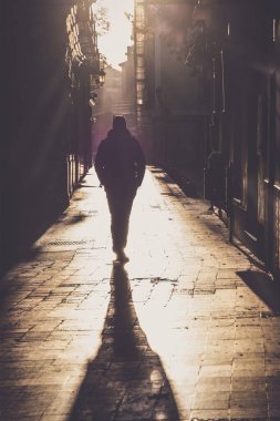 Man walking on the narrow strees of Zaragoza, Spain
