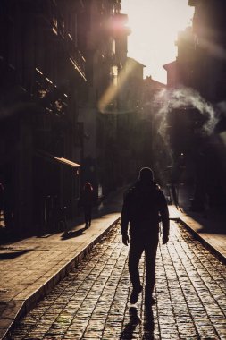 Man walking on the narrow strees of Zaragoza, Spain