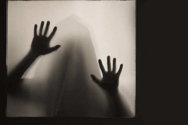 Horror, halloween background - Shadowy figure behind glass