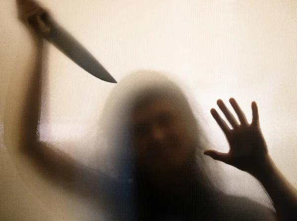 ホラー ハロウィンの背景 ナイフを持つガラスの後ろの影像 — ストック写真