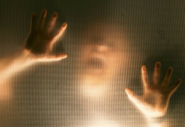 Horror ghost man behind the matte glass. Halloween festival concept.