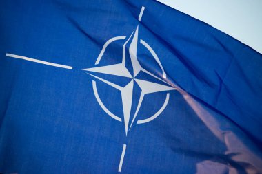 NATO (North Atlantic Treaty Organization) flag waving. NATO is an international military alliance that constitutes a system of collective security