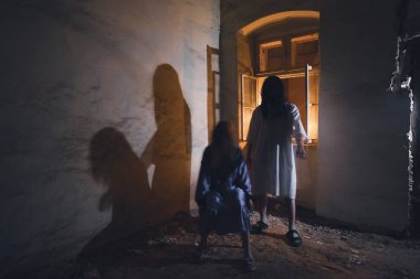 Ghosts in abandoned, haunted house. Horror scene of scary spirit of a couple, halloween concept.
