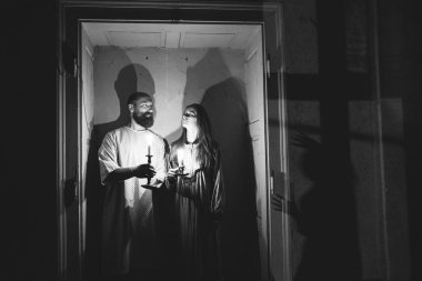 Ghosts in abandoned, haunted house. Horror scene of scary spirit of a couple, halloween concept.