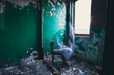 Ghost in abandoned, haunted house. Horror scene of scary spirit of a woman, halloween concept.