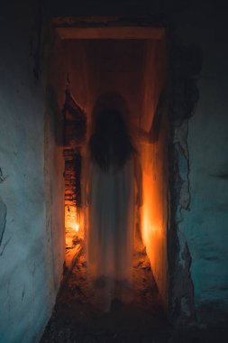 Ghost in abandoned, haunted house. Horror scene of scary spirit of a woman, halloween concept.