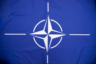 NATO (North Atlantic Treaty Organization) flag waving. NATO is an international military alliance that constitutes a system of collective security