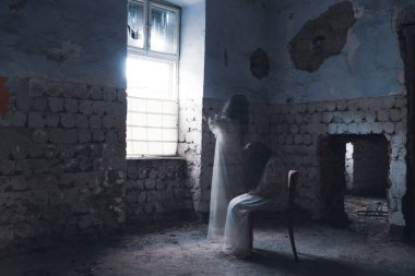 Ghost in abandoned, haunted house. Horror scene of scary spirit of a woman, halloween concept.