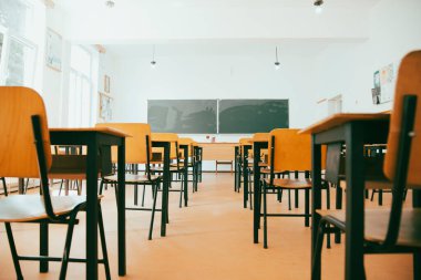 Okul Konseptine geri dönelim. Sandalyeleri, masaları ve tahtası olan boş bir sınıf.