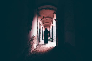Ghost in abandoned, haunted house. Horror scene of scary spirit of a woman, halloween concept.