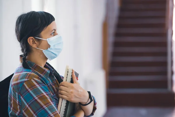 Student with face mask back at college or university, coronavirus concept.