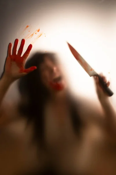 Horror Halloween Background Shadowy Figure Glass Holding Knife Blooded Hands — Stock Photo, Image