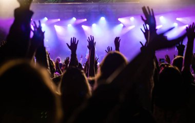Konserde kalabalık - Parlak renkli sahne ışıkları önünde tezahürat yapan kalabalık