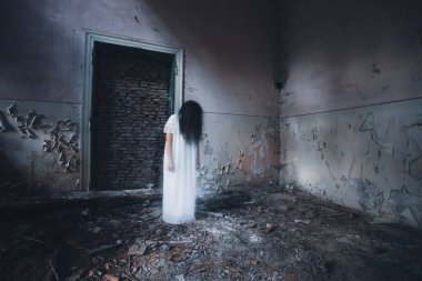 Ghost in abandoned, haunted house. Horror scene of scary spirit of a woman, halloween concept.