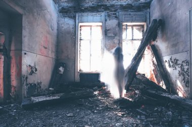 Ghost in abandoned, haunted house. Horror scene of scary spirit of a woman, halloween concept.