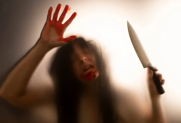 Horror Halloween Background Shadowy Figure Glass Holding Knife Blooded Hands — Stock Photo, Image