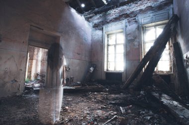 Ghost in abandoned, haunted house. Horror scene of scary spirit of a woman, halloween concept.