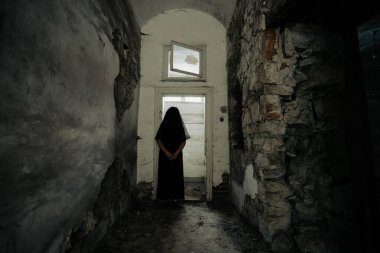Ghost in abandoned, haunted house. Horror scene of scary spirit of a woman, halloween concept.