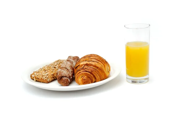 Breakfast bread and a glass of orange juice — Stock Photo, Image