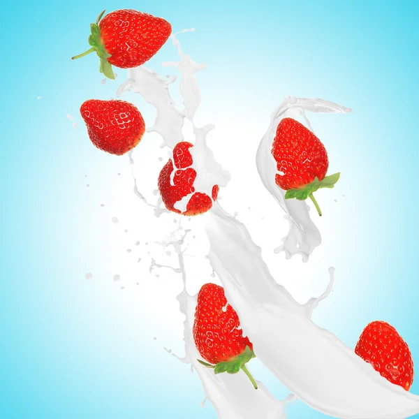 Strawberries in milk splash — Stock Photo, Image