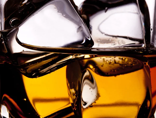 Whiskey splash with ice cubes — Stock Photo, Image