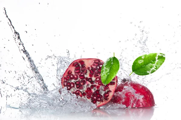 Šťavnaté granátové jablko s šplouchání vody — Stock fotografie