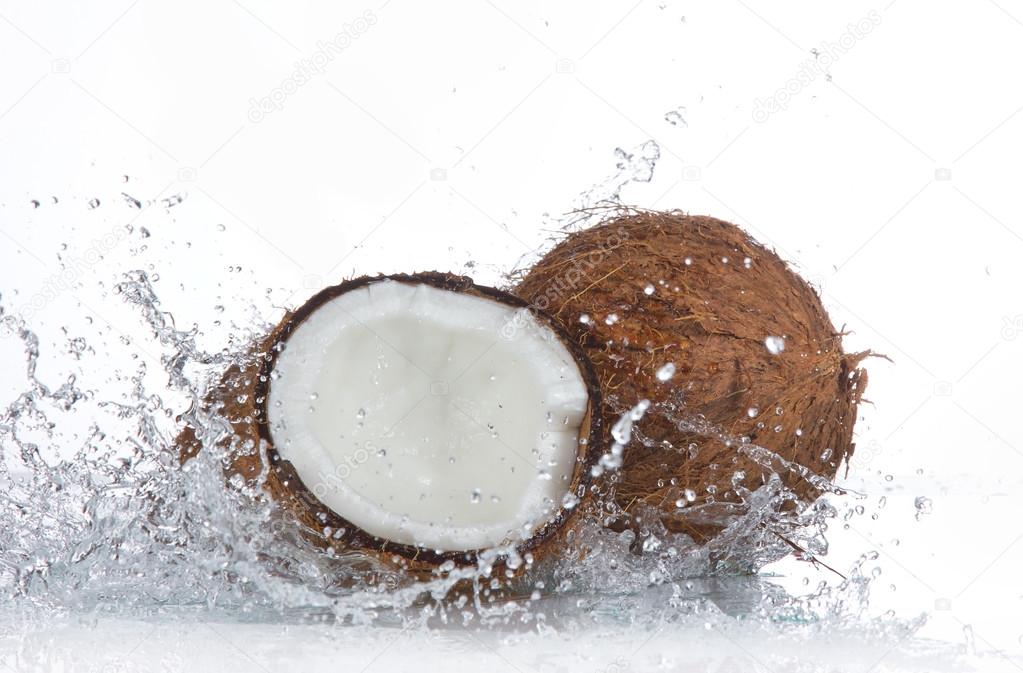 Cracked coconut with splashing water