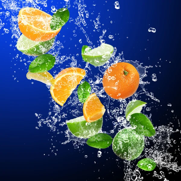 Tropical fruits in water splash — Stock Photo, Image