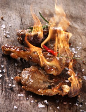Delicious lamb chops with flames clipart