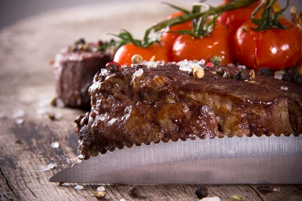 Delicious beef steaks with knife — Stock Photo, Image