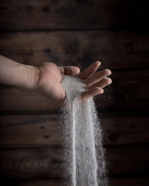 Sand running through hand — Stock Photo, Image