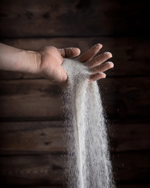 Sand running through hand — Stock Photo, Image