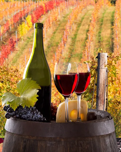 Wine bottle and glasses on wooden table — Stock Photo, Image