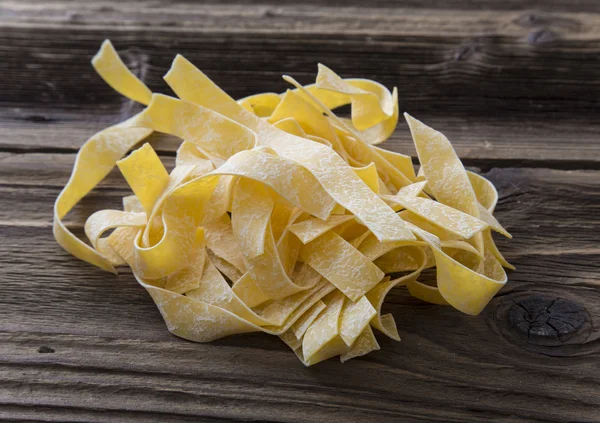 Spilled raw pappardelle pasta — Stock Photo, Image
