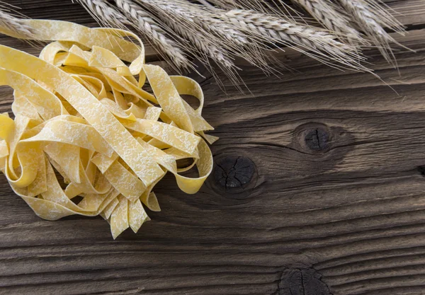 Spilled raw pappardelle pasta — Stock Photo, Image