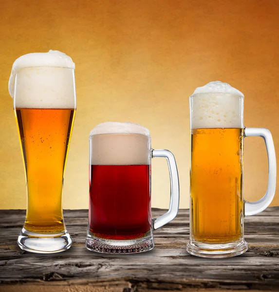 Glasses of beer on wooden table — Stock Photo, Image