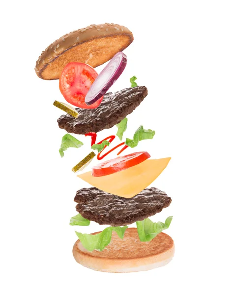 Lahodný hamburger s létáním ingredience — Stock fotografie