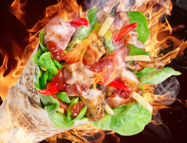 Chicken slices in a Tortilla with fire. — Stock Photo, Image
