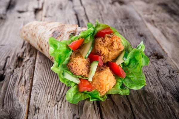 Chicken strips in a Tortilla Wrap on wood. — Stock Photo, Image