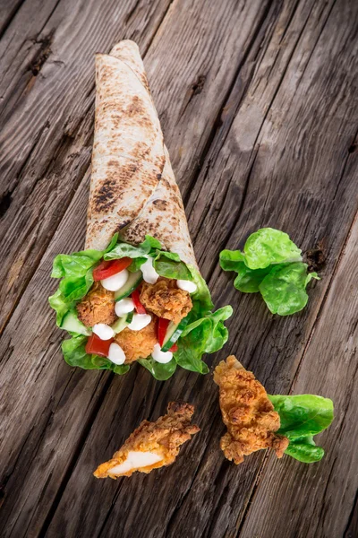 Chicken strips in a Tortilla Wrap on wood. — Stock Photo, Image