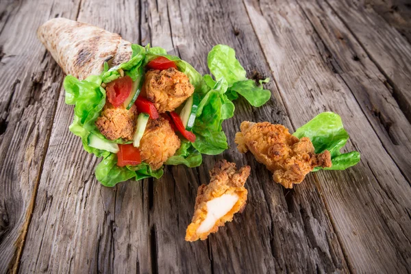 Chicken strips in a Tortilla Wrap on wood. — Stock Photo, Image