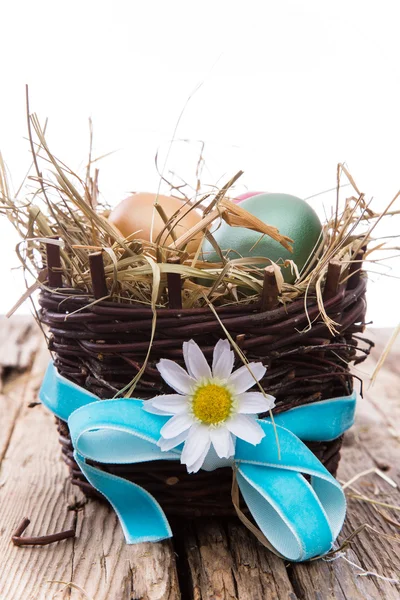 Easter colored eggs on hay — Stock Photo, Image