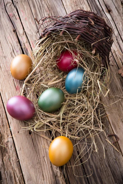 Easter colored eggs on hay — Stock Photo, Image